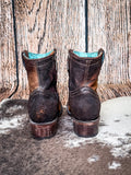 back of boots on cowhide, wood backdrop