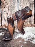boots on cowhide, wood backdrop