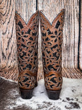 back of boots on cowhide, wood backdrop