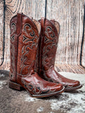 boots on cowhide, wood backdrop