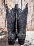 back of boots on cowhide, wood backdrop