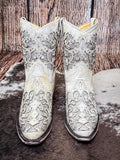 front of boots on cowhide, wood backdrop