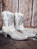 boots on cowhide, wood backdrop