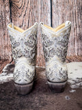 back of boots on cowhide, wood backdrop