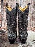 back of boots on cowhide, wood background