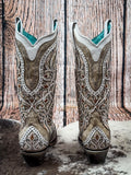 back of boots on cowhide, wood backdrop