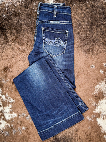 Trouser jeans folded on cowhide.