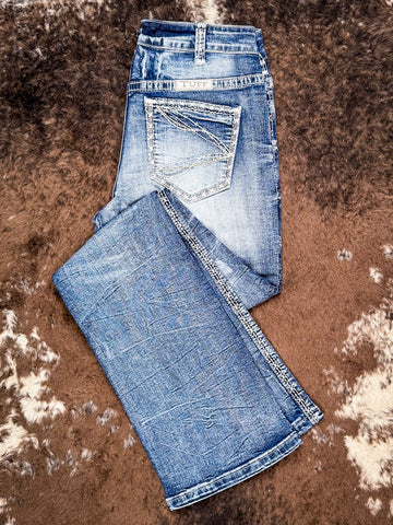 Bootcut jeans folded on cowhide.