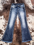 Full view of jeans laying on cowhide.