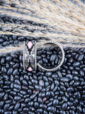 Earrings displayed on wheat and beans.