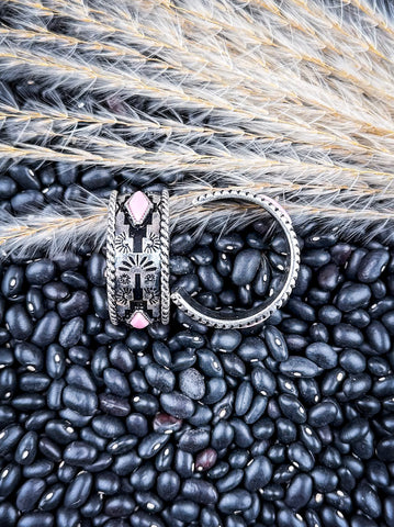Earrings displayed on wheat and beans.