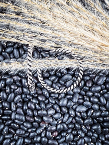Earrings displayed on wheat and beans.