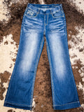 Front view of trouser jeans displayed on cowhide.