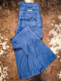 Boot cut Jeans displayed on cowhide.