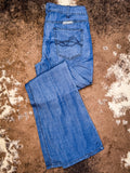 Boot cut Jeans displayed on cowhide.