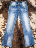 Front view of boot cut jeans displayed on cowhide.