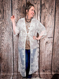 Model posing with one arm bent to show off embroidered detail.