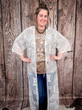 Model smiling with hands on her waist showing the sleeves of the duster.