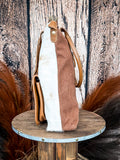 Side view of the Mesa Maverick Tote displayed on wood background.