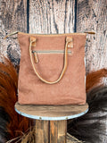 Back view of the Mesa Maverick Tote displayed on wood background.