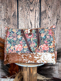 Front view of the Fyole Weekender bag on a wood backdrop. 