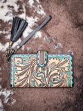 Flat lay view of the Western Swing Wristlet on cowhide.