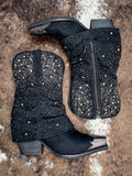 Flat lay of Stardust Glitter Bootie in Black By Very G on cowhide.