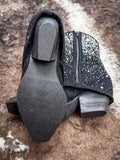 View of the sole of the Stardust Glitter Bootie in Black By Very G on cowhide.