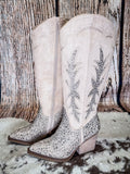 Side view of the Addie Glitter Knee High Boot in Taupe By Very G on a wood backdrop.