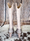 Back view of the Addie Glitter Knee High Boot in Taupe By Very G on a wood backdrop.