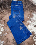 Folded Cowgirl Tuff Pull-On Star Trouser laying on cowhide.