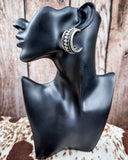 Twist and Timber Fashion Hoop Earrings on mannequin, sitting on cow hide, wood back drop.