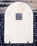 Trailblazer Concho Fashion Stud square earring on a ruler, displayed on beans and wheat.