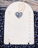 Trailblazer Concho Fashion Stud heart earring on a ruler, displayed on beans and wheat. 