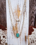 Arrow Rock Trail Fashion Necklace displayed on a wood plank, sitting on cow hide.