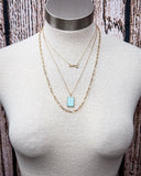 Arrow Rock Trail Fashion Necklace shown on a mannequin, wood back drop.