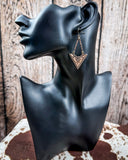 Mesa Sunrise Fashion Dangle Earrings on mannequin sitting on cowhide, wood backdrop.