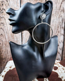 High Desert Concho Fashion Hoops on a mannequin, sitting on cowhide, wood back drop.