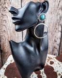 Blue Mesa Fashion Hoops on a mannequin, sitting on cow hide, wood back drop.