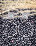 Outlaw Square Hoop Fashion Earrings displayed on beans and wheat.