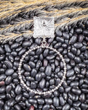 Outlaw Square Hoop Fashion Earrings displayed on beans and wheat.