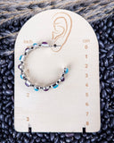 Canyon Bloom Fashion Hoop Earrings on a ruler, displayed on beans and wheat.