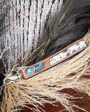 Far & Wide Hand-Tooled Key Fob displayed on wheat, wood back drop.