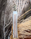 Diamond Shine Hand-Tooled Strap Key Fob displayed on wheat, wood back drop.