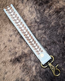 Diamond Shine Hand-Tooled Strap Key Fob displayed on cow hide.