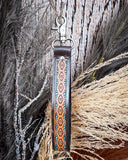 Canyon Spire Key Fob in Multicolor displayed on wheat, wood back drop.