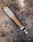 Canyon Spire Key Fob in Multicolor displayed on cowhide.