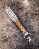 Canyon Spire Key Fob in Multicolor displayed on cowhide.