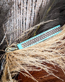 Teal Accent Hand-Tooled Strap Key Fob displayed on wheat, wood backdrop.