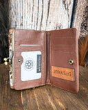 Inside of the Mesa Terra Vintage Style Wallet, displayed on a wood table with a wood backdrop.